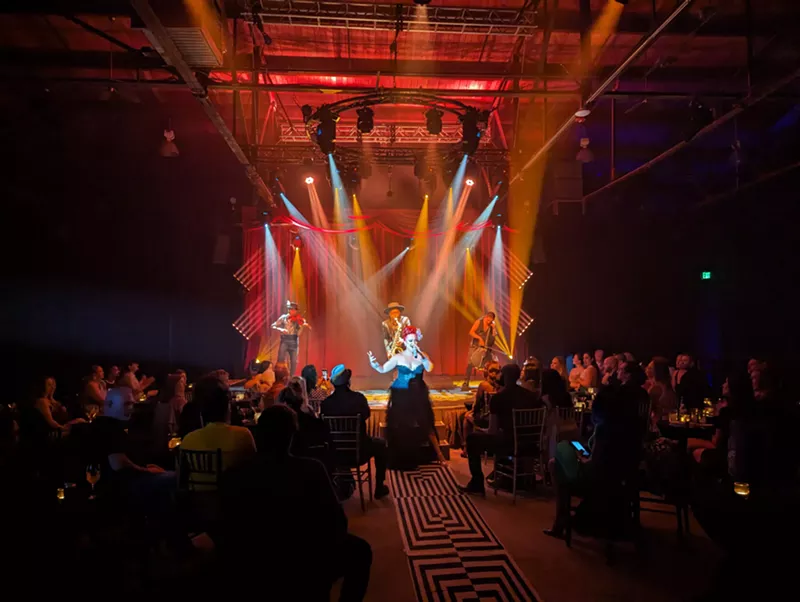 Image: cabaret performers stand on a stage