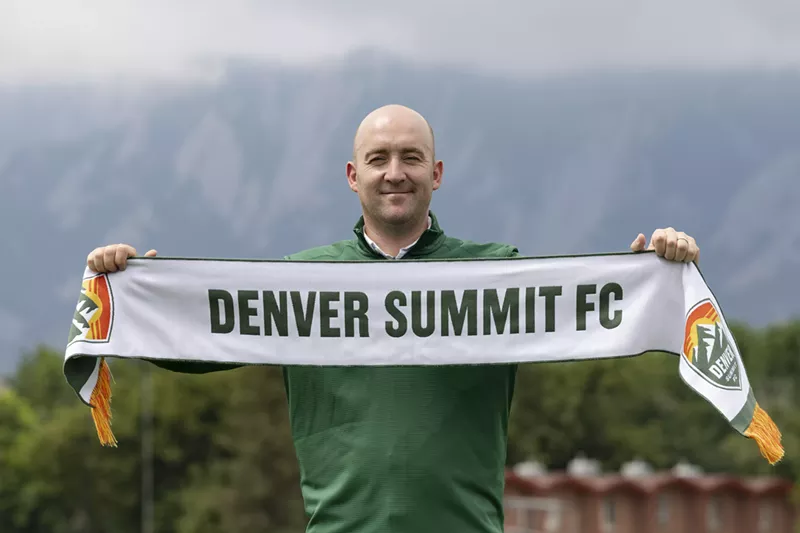 Image: Man holds Denver Summit FC scarf