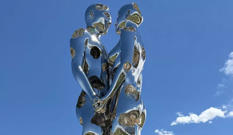 Image: sculpture of metalic man and woman