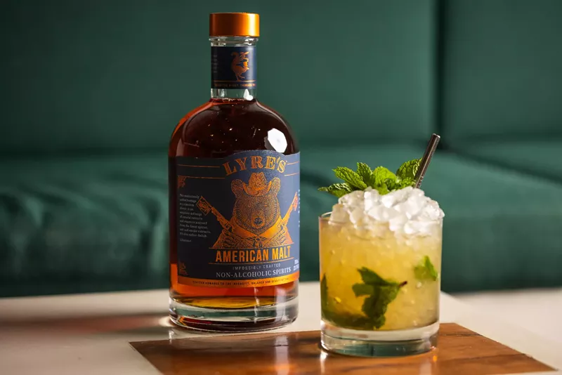 Image: a bottle next to a cocktail in a glass