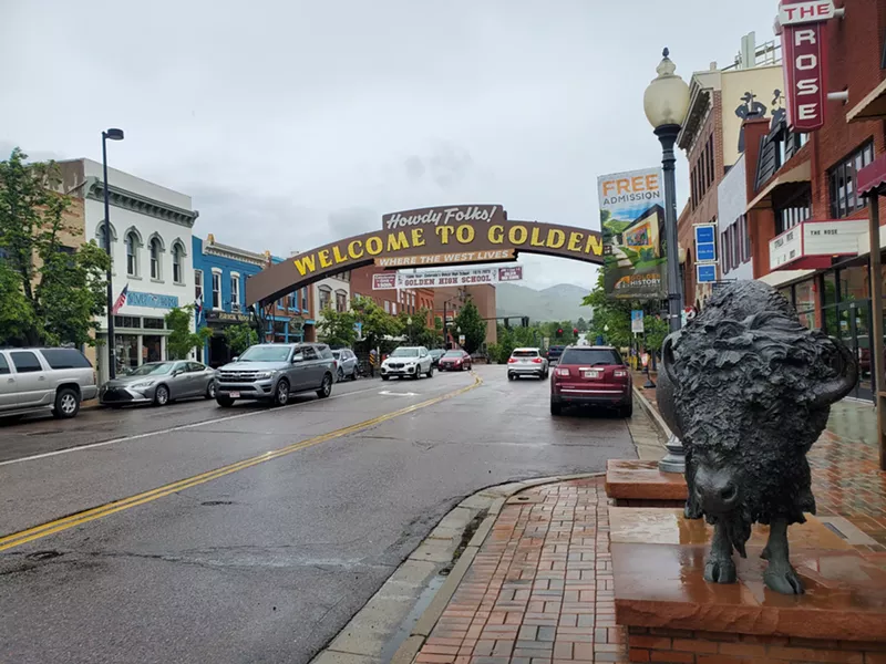 Image: a sign arching over a street that says welcome to Golden