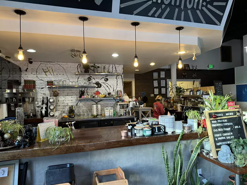 Image: dog mural behind a bar inside a restaurant