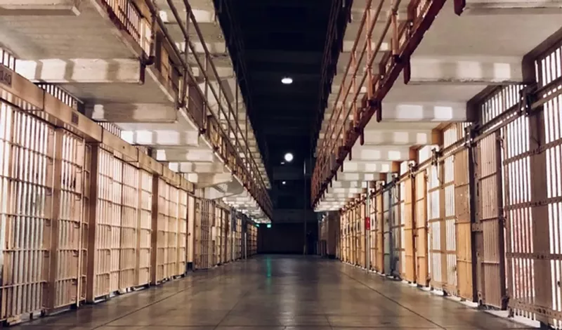 Image: inside of prison with cells