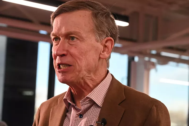 Image: John Hickenlooper talks to reporters.