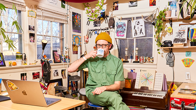 artist sitting in a studio drinking coffee