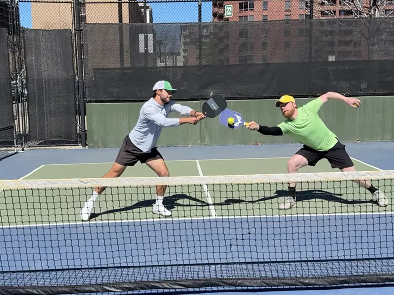 Image: Men play pickleball with cushioned paddles