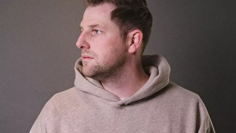 Image: man in a tan sweatshirt