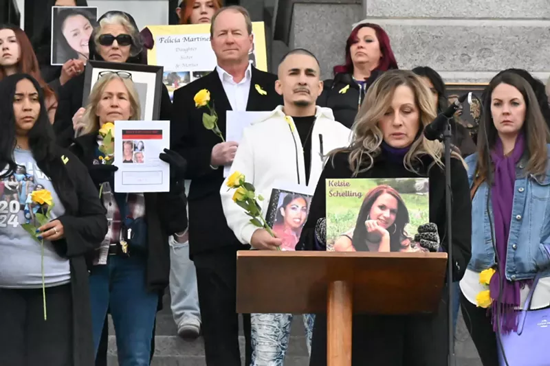 Image: Laura Saxton reads the name of her daughter, Kelsie Shelling, and holds up her picture as part of the tenth annual Colorado Missing Persons ceremony on Tuesday, February 4.