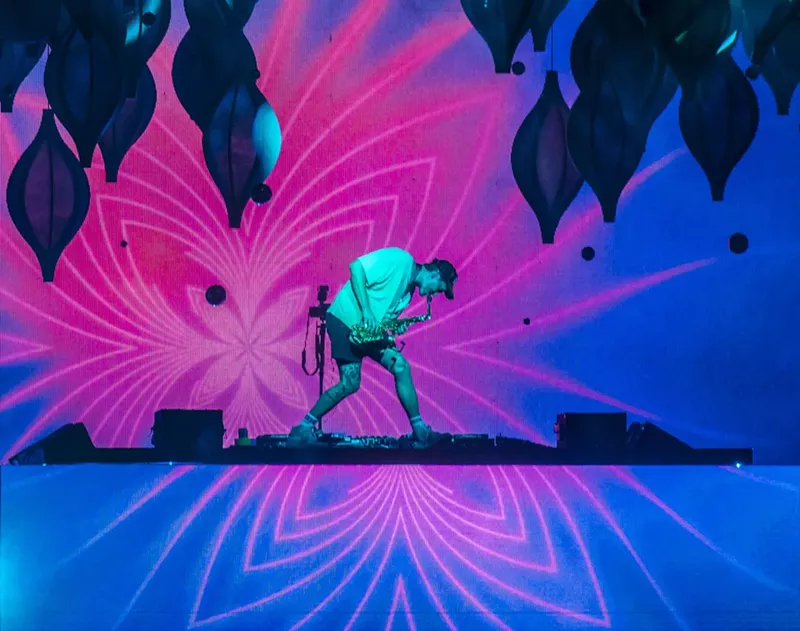 Image: musician against psychedelic background.