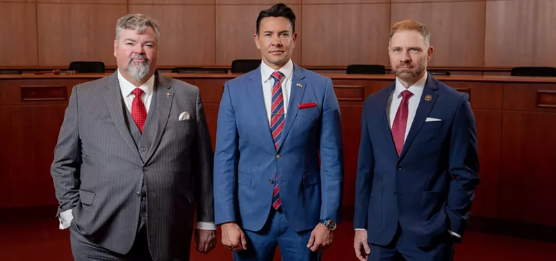Image: three men in suits.