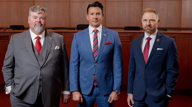 three men in suits.