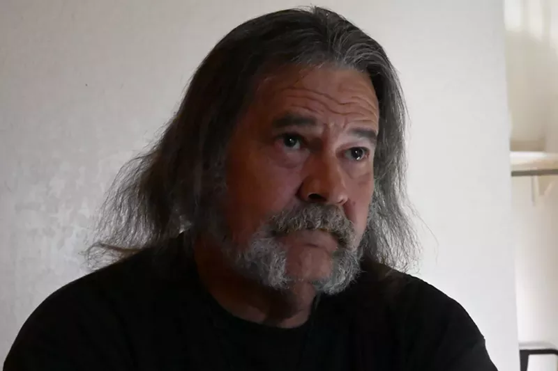 Image: Man with long hair and beard gives interview