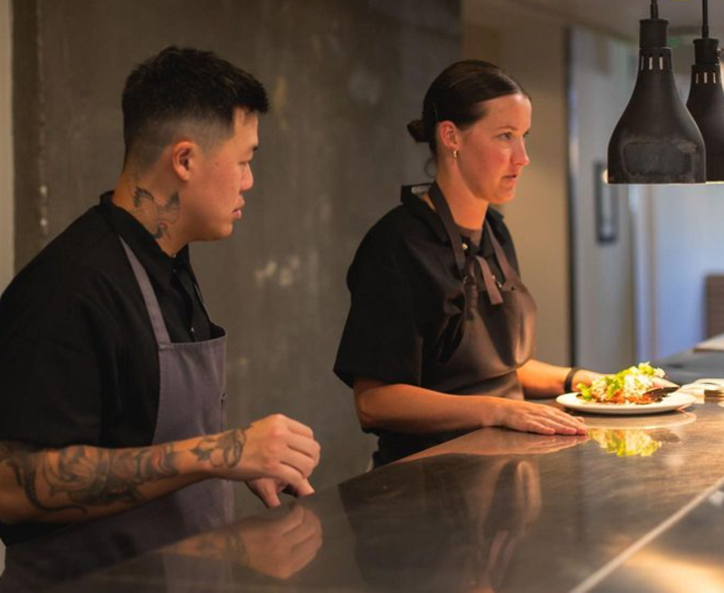 Image: two chefs standing at a counter