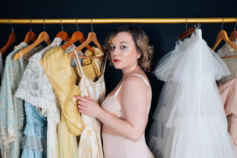 Image: woman looking at clothes in a closet