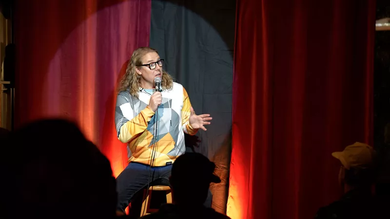 Image: comedian pat treuer on stage