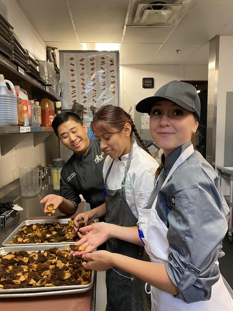 Two ProStart students prep morels with chef Thach Tran at Ace Eat Serve.