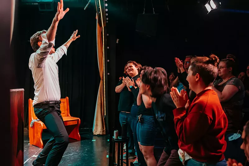 Image: actors on stage and audience clapping