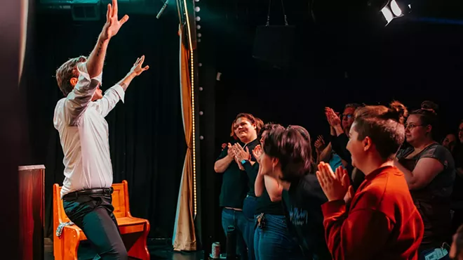 actors on stage and audience clapping