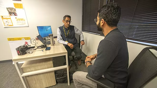 A refugee speaks to another refugee.
