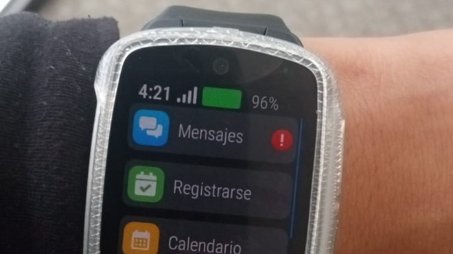 A watch device on someone's wrist.
