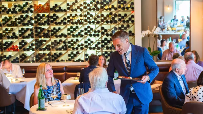 man pouring wine