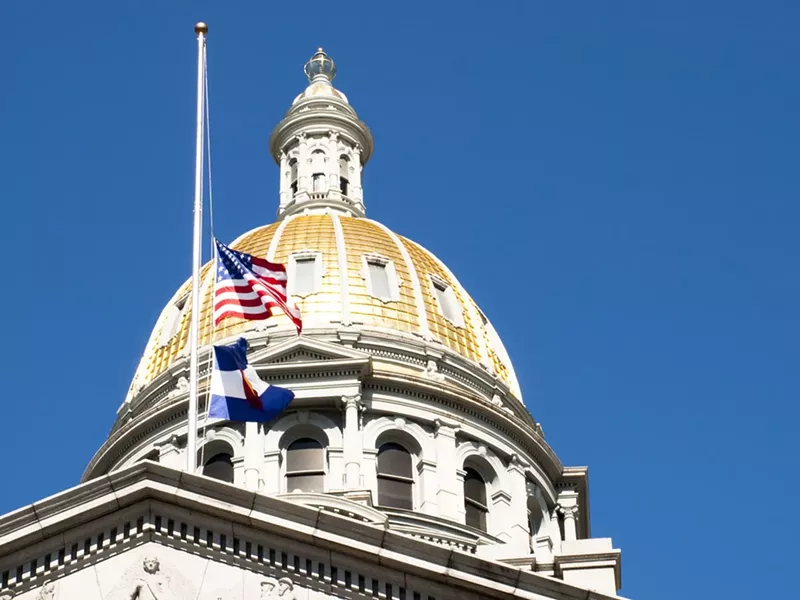 Image: A gold-capped building sits against a blue sky.
