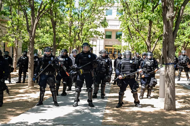 Image: Aurora police lined up against protesters demanding justice for Elijah McClain.