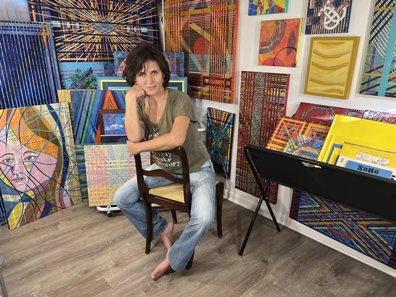 Image: A woman poses in a studio.