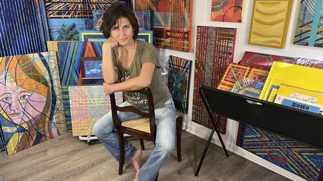 A woman poses in a studio.