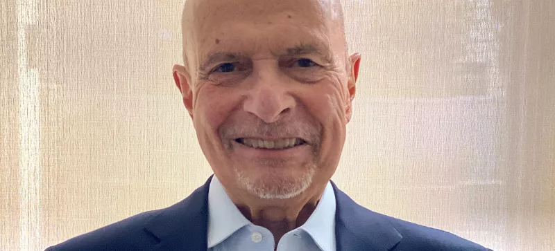 Image: elderly man looking at camera.