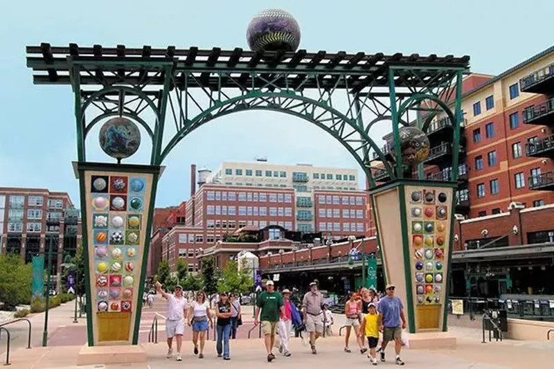 Image: sculpture outside ballpark with fans