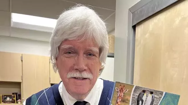 Man holds a book.