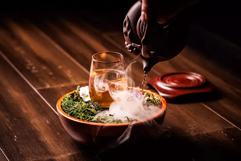 Image: cocktail on a bed of moss with mist