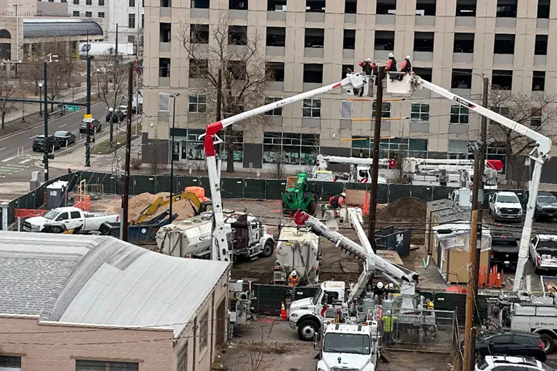Image: Workers toy with the wiring at the micro-community at the 1375 Elati Street.