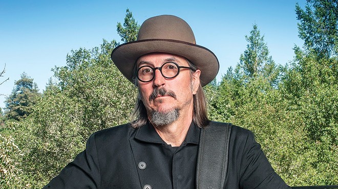 man wearing a hat, glasses and goatee