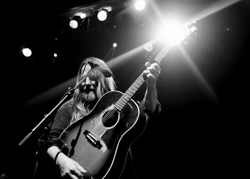 Image: man playing a guitar