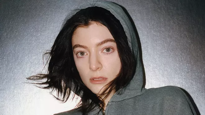 the singer Lorde in a grey sweatshirt