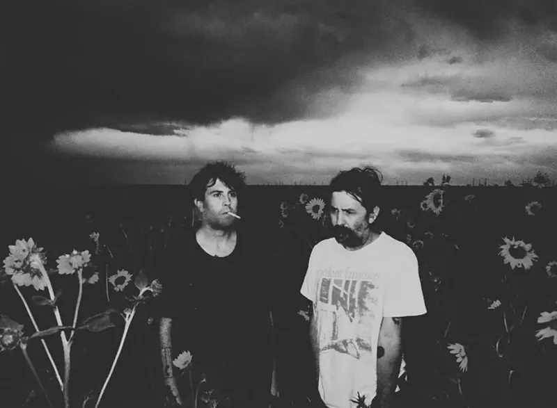 Image: two men standing in a field