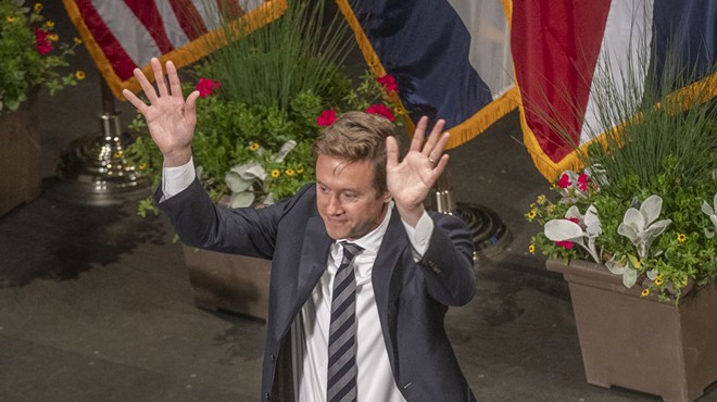 new mayor in tie raises hands