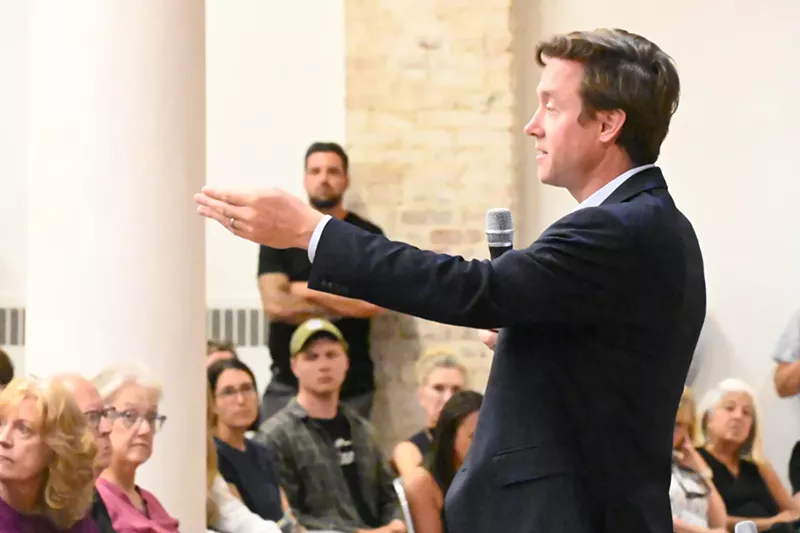 Image: Mike Johnston speaks during a town hall in the Golden Triangle.