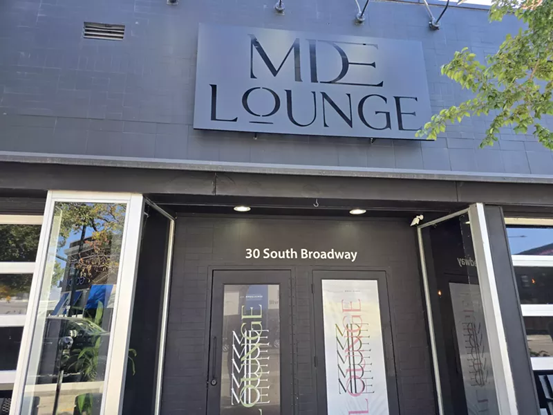 Image: "mde lounge" sign over a door