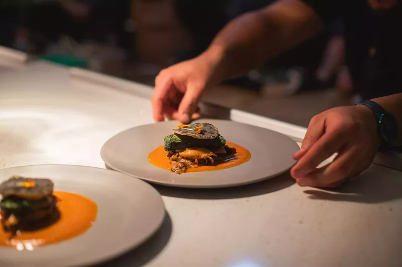Image: hands reaching for a plate