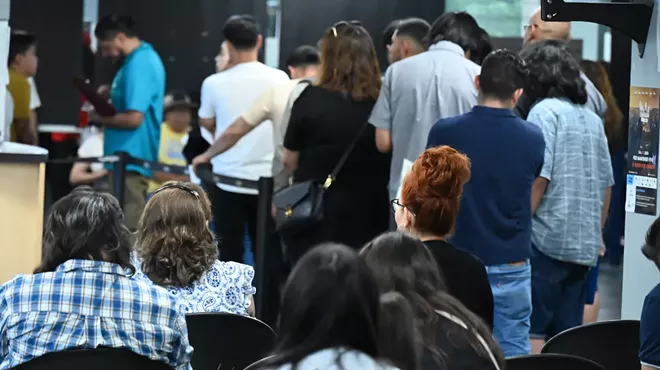 People wait at a consulate.