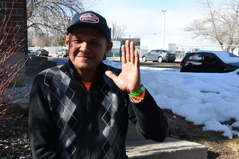 Image: A migrant waves hi.