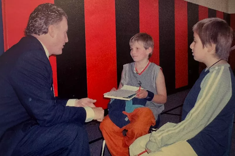 Image: Two boys interview a man.
