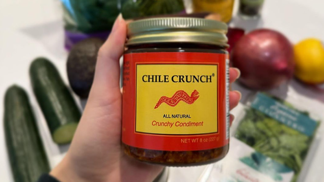 hand holding a jar of Chile Crunch