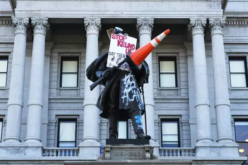 Image: soldier statue with graffiti
