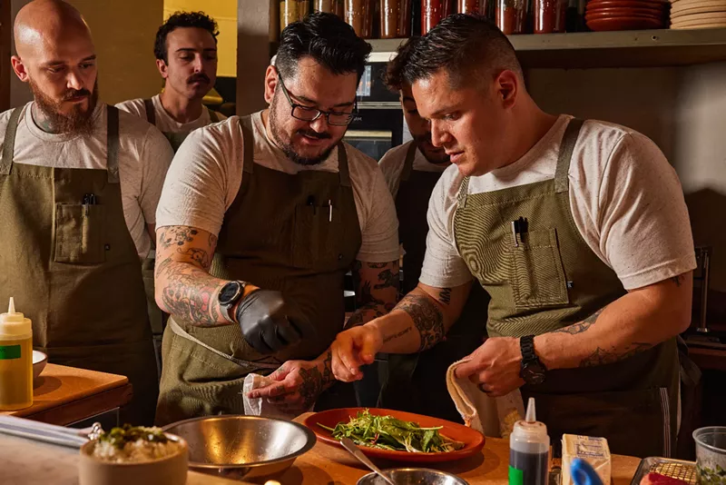 Image: three menu in green aprons