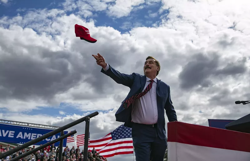 Image: Mike Lindell of MyPillow tosses a MAGA hat into the air