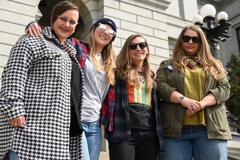Image: Women smile and look at the camera.